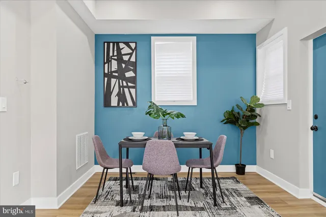 a view of a dining room with furniture and wooden floor