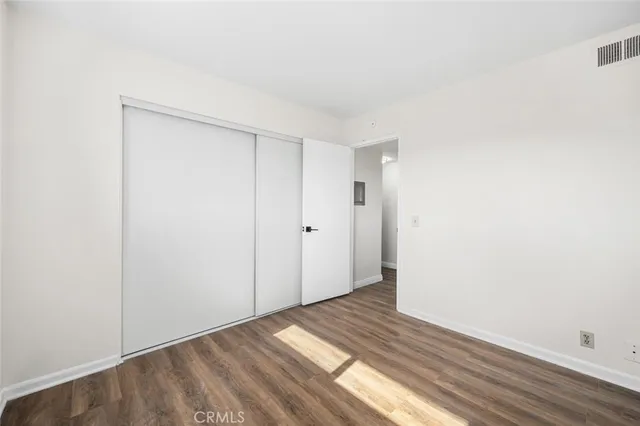 a view of an empty room and wooden floor