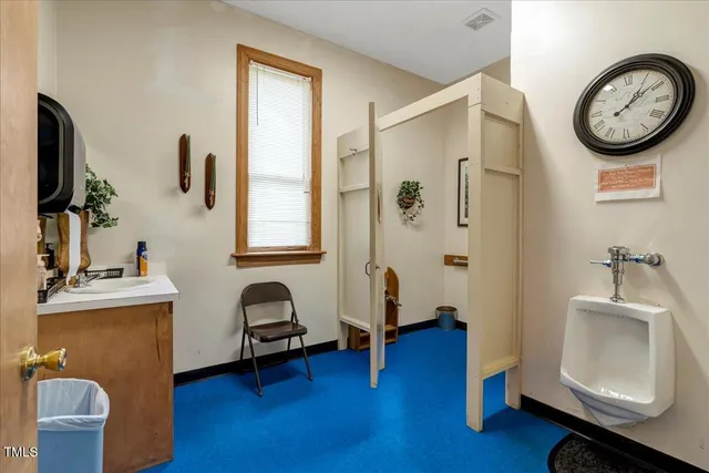 a view of a hallway with wooden floor and closet