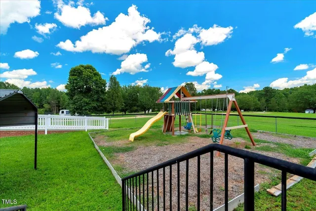 a view of an house with backyard and porch