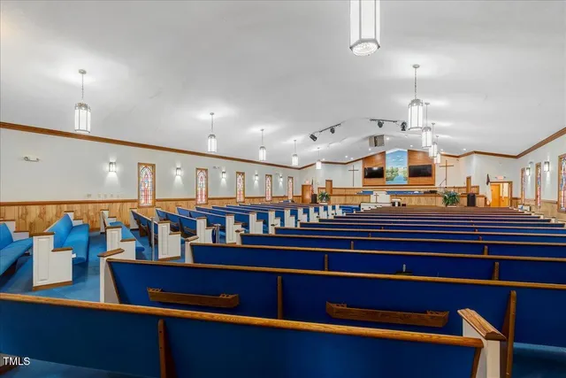 a room with lots of wooden furniture and a chandelier