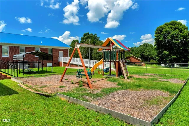 a view of an house with backyard and a patio