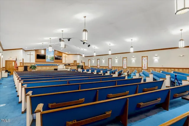 a living room with lots of furniture and a wooden floor