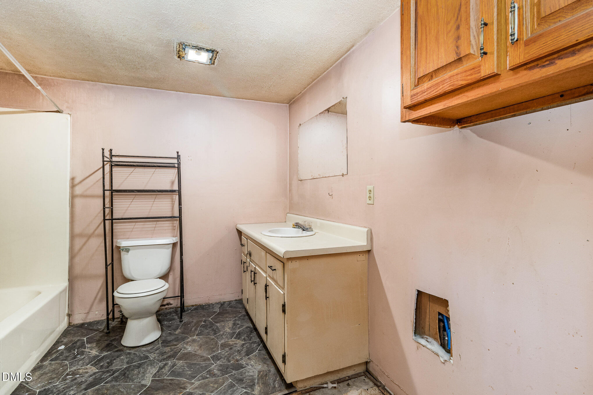495 Horseshoe Road Aberdeen, NC 28315 - Photo 12 of 16 a bathroom with a toilet sink and mirror