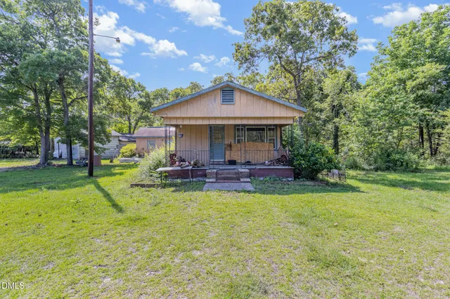 a view of a house with pool and a bench