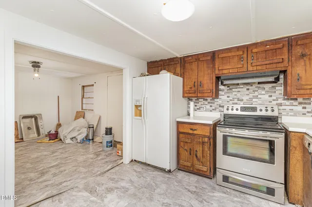 a kitchen with a stove and a refrigerator