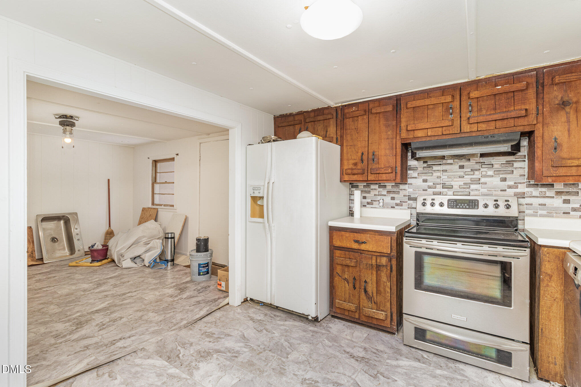 495 Horseshoe Road Aberdeen, NC 28315 - Photo 8 of 16 a kitchen with a stove and a refrigerator
