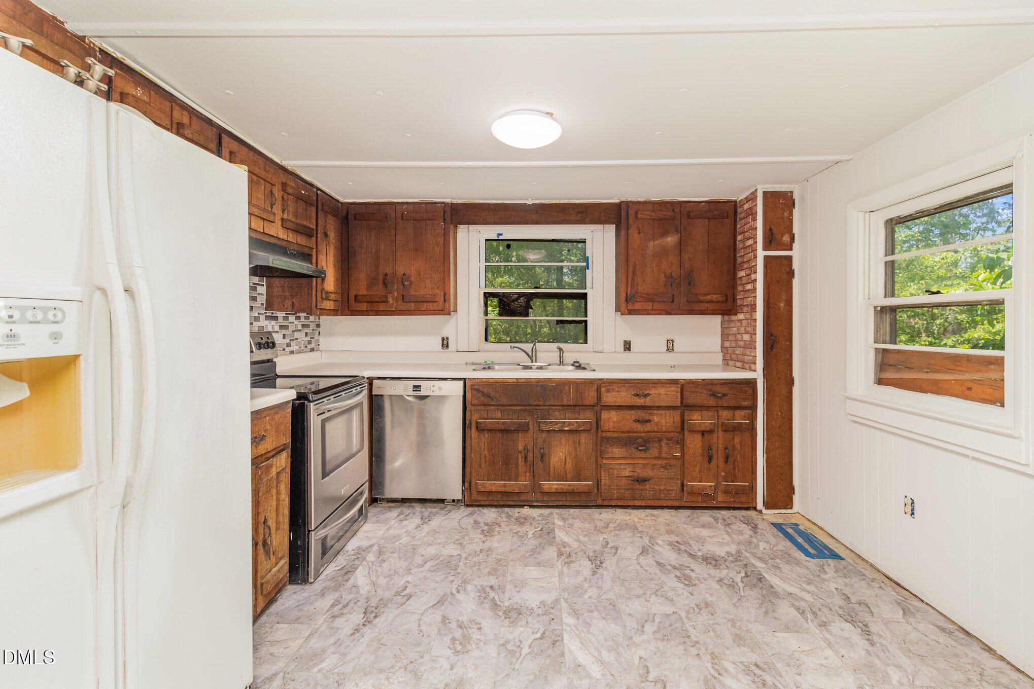 495 Horseshoe Road Aberdeen, NC 28315 - Photo 9 of 16 a kitchen with a sink window and cabinets
