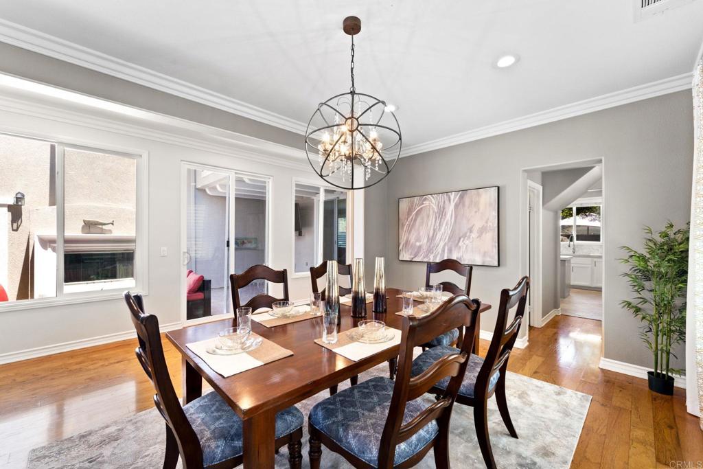 871 First Light Road San Marcos, CA 92078 - Photo 2 of 45 a dining room with furniture a chandelier and wooden floor