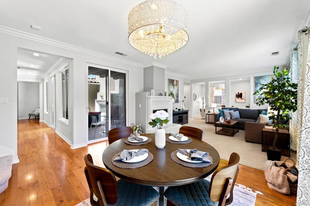 871 First Light Road San Marcos, CA 92078 - Photo 26 of 45 a view of a dining room and livingroom with furniture wooden floor a chandelier