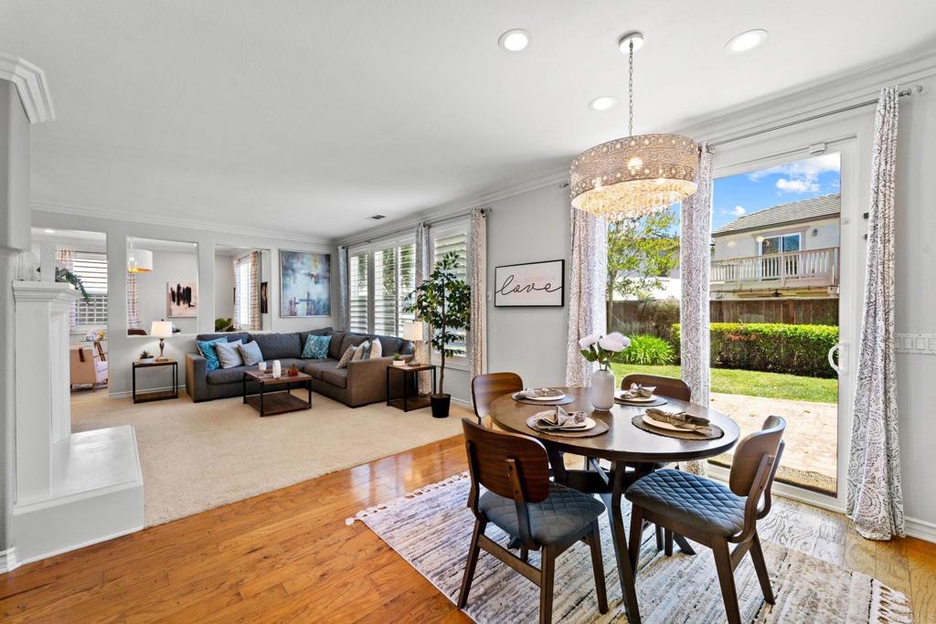 871 First Light Road San Marcos, CA 92078 - Photo 27 of 45 a view of a dining room and livingroom with furniture wooden floor a chandelier