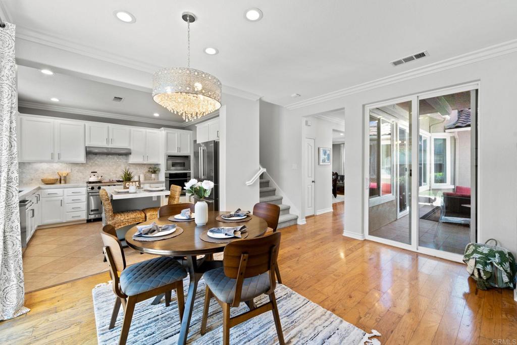 871 First Light Road San Marcos, CA 92078 - Photo 29 of 45 a view of a dining room with furniture and wooden floor