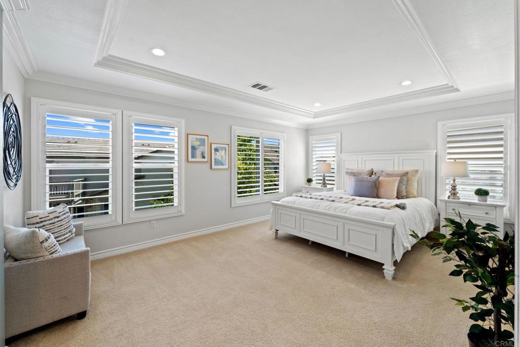 871 First Light Road San Marcos, CA 92078 - Photo 3 of 45 a spacious bedroom with a bed and a couch