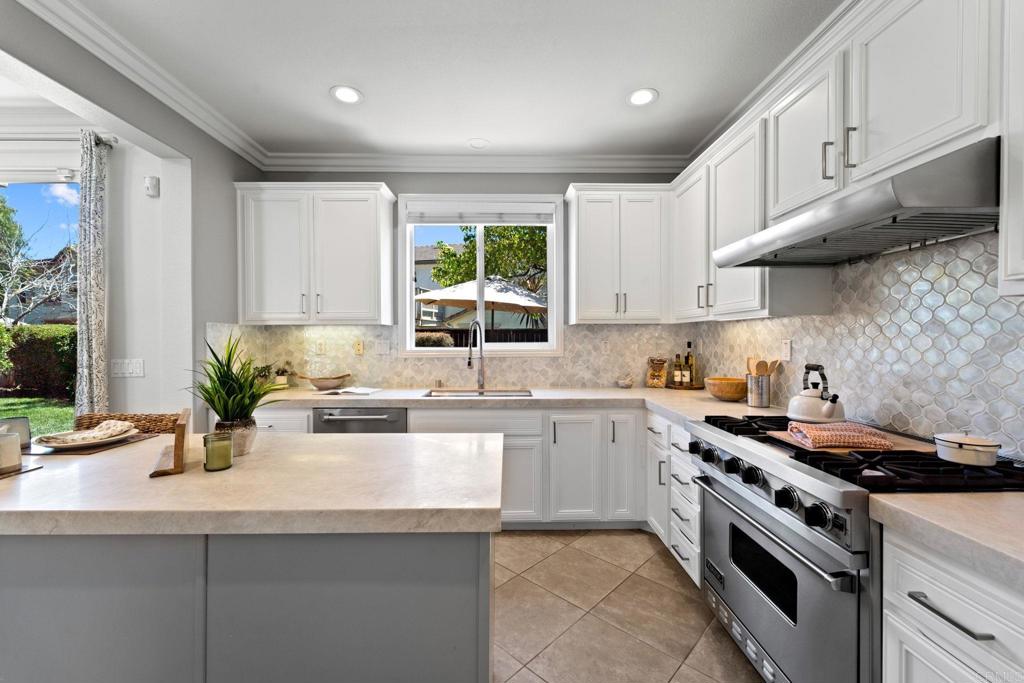 871 First Light Road San Marcos, CA 92078 - Photo 35 of 45 a kitchen with stainless steel appliances granite countertop a sink a stove and a window