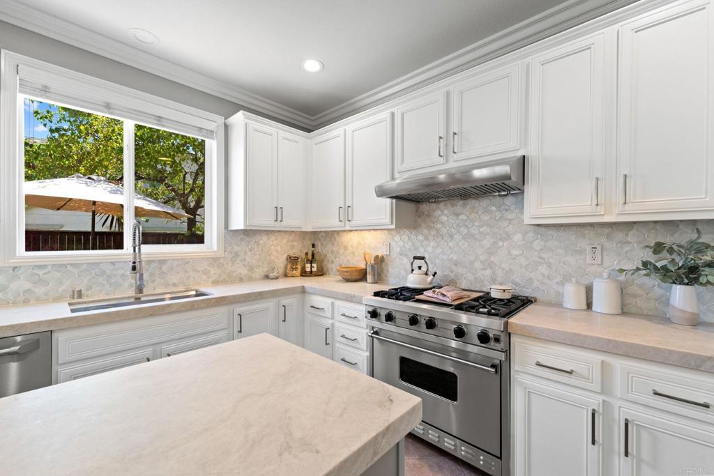 871 First Light Road San Marcos, CA 92078 - Photo 37 of 45 a kitchen with stainless steel appliances white cabinets and a stove top oven
