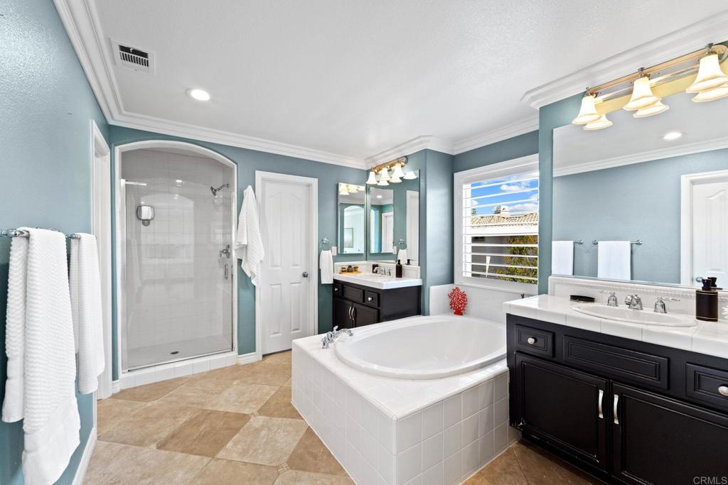 871 First Light Road San Marcos, CA 92078 - Photo 4 of 45 a bathroom with a tub sink shower and mirror