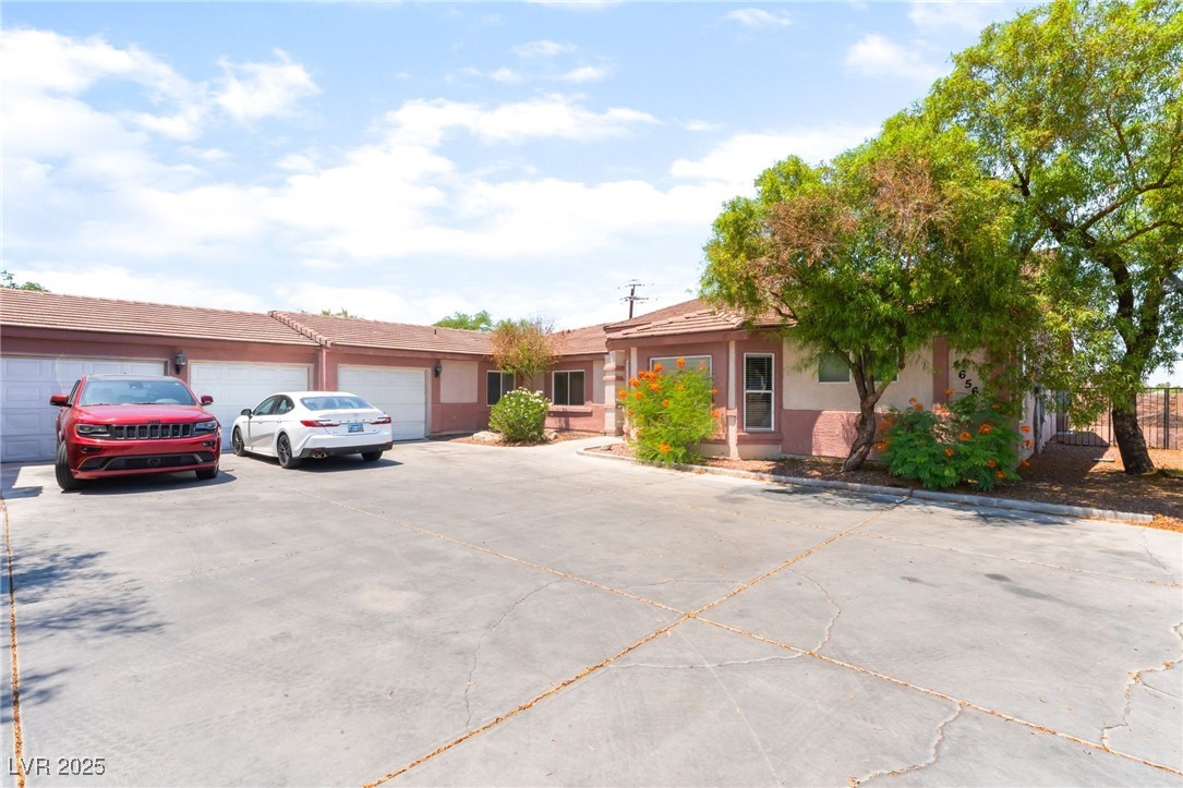 4656 East Desert Inn Road Las Vegas, NV 89121 - Photo 1 of 98 4656 E DI View of front of property with driveway, a garage, and stucco siding