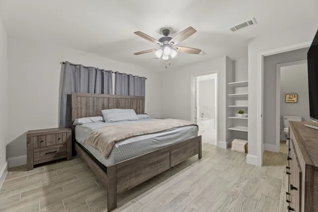 a bedroom with a bed and a chandelier