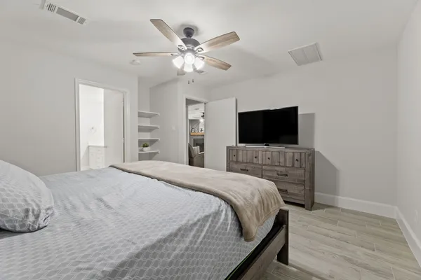 a bedroom with a bed and a flat screen tv