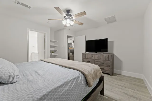 a bedroom with a bed and a flat screen tv