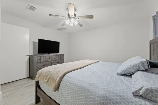 a bedroom with a bed and a flat screen tv