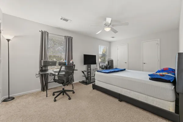 a bedroom with a bed and a desk
