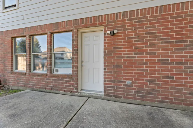 a view of a backyard with a small pool and wooden fence