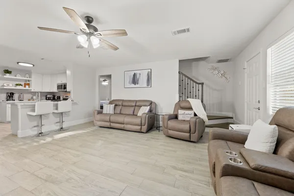 a living room with furniture and kitchen view