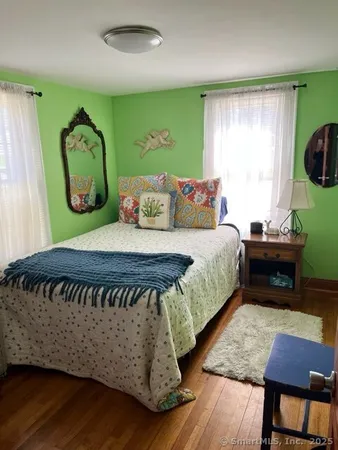 a bedroom with a bed table and window