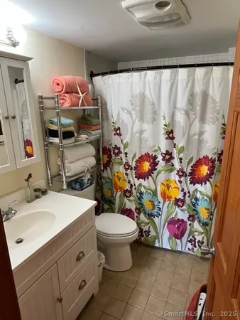 a bathroom with a sink mirror vanity and toilet