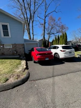 a view of a car parked in front of a brick house
