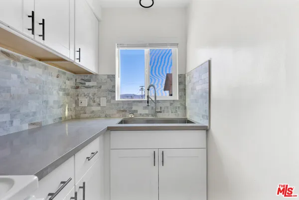 a kitchen with a sink and cabinets