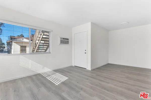 a view of wooden floor and windows in a room