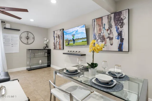 a living room with furniture and wall paintings