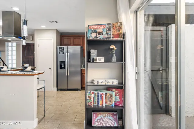 a kitchen with stainless steel appliances granite countertop a refrigerator and a refrigerator