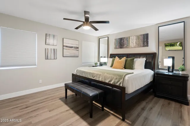 a bedroom with a bed and wooden floor