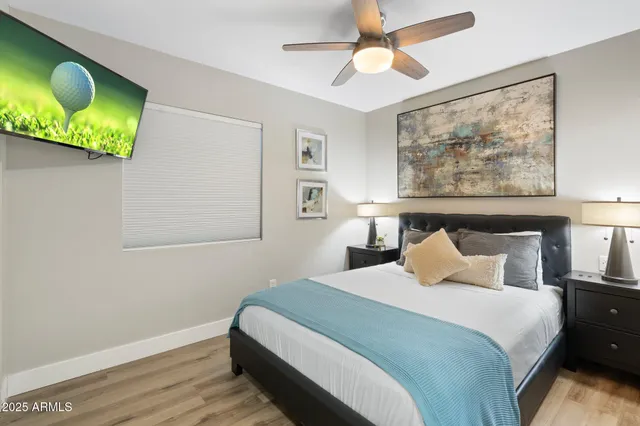 a bedroom with beds and painting on the wall