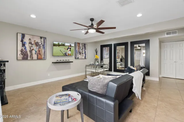 a living room with furniture a chandelier and a large window