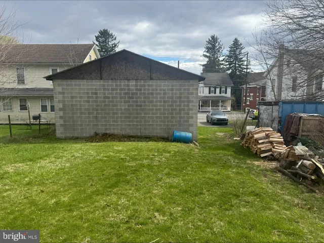 a view of a backyard with table and chairs
