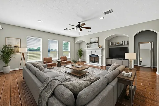 a living room with furniture fireplace and a flat screen tv