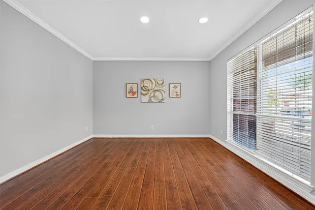 a view of a room with wooden floor and a window
