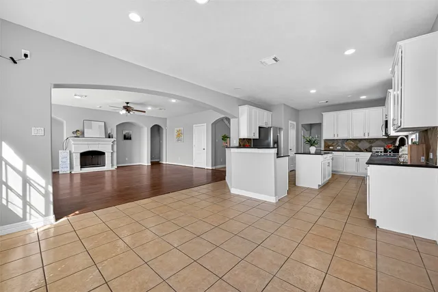a large white kitchen with cabinets