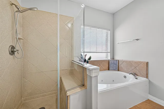 a bathroom with a tub and shower