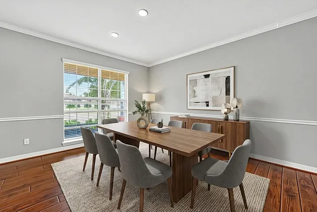 a view of a dining room with furniture window and wooden floor