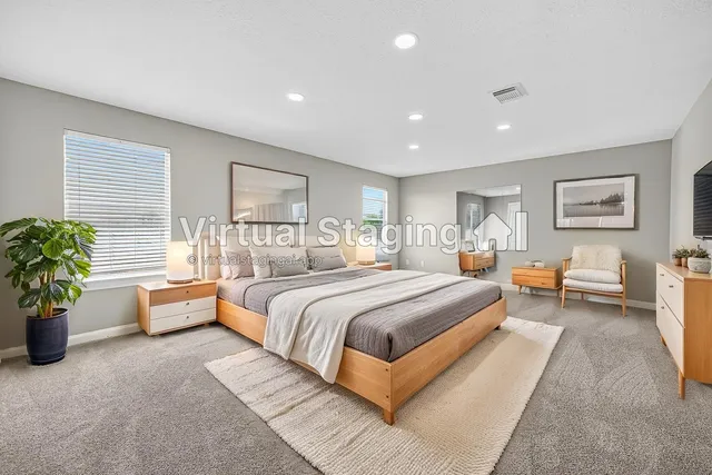 a spacious bedroom with a bed and potted plant