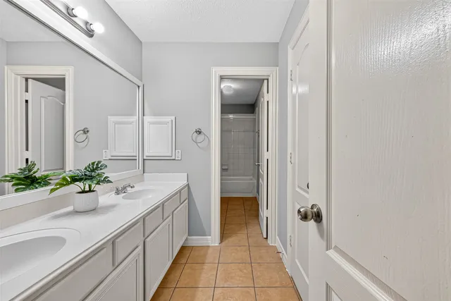 a spacious bathroom with a sink and a mirror