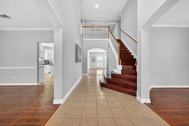 a view of a hallway with entryway wooden floor and front door