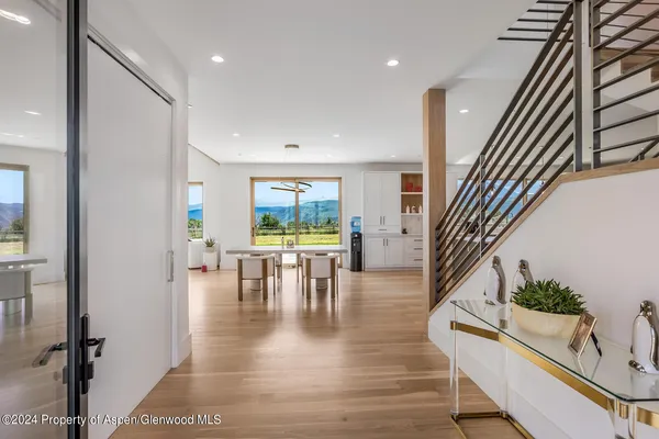 a view of a living room and a floor to ceiling window and wooden floor