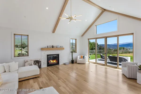 a living room with stainless steel appliances kitchen island granite countertop a refrigerator and a stove top oven