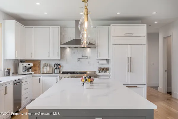 a large kitchen with a table and chairs